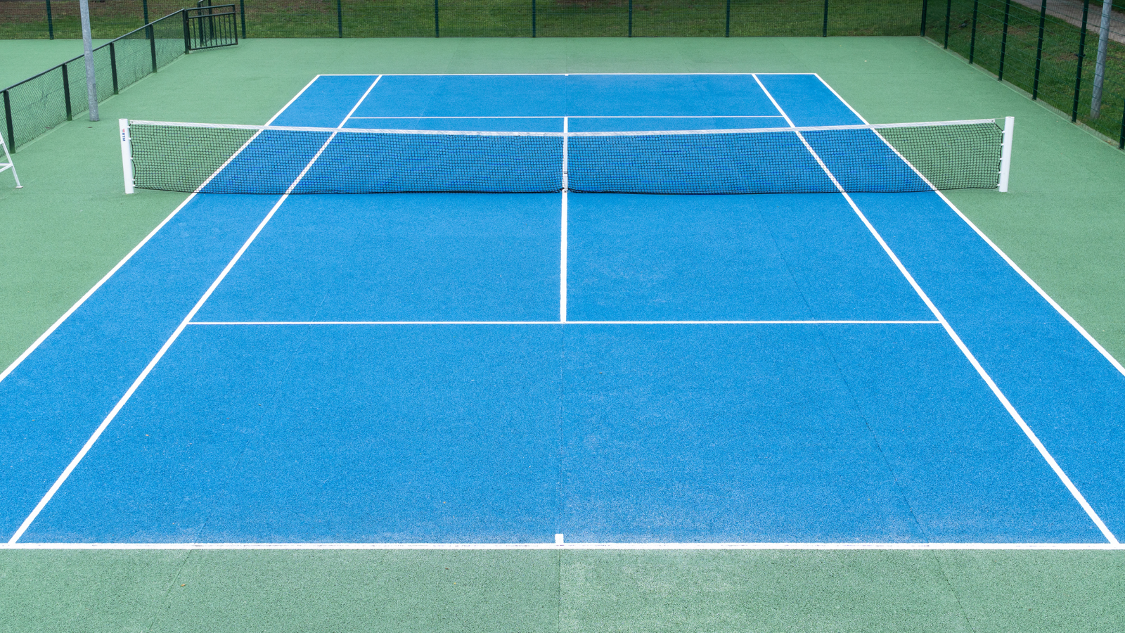 Players enjoying a dynamic game on the paddle tennis court, showcasing strategy and skill in every swing.