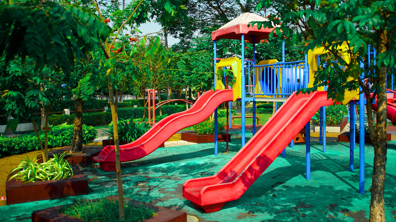 Colorful playground slide with children playing, showcasing different slide designs.