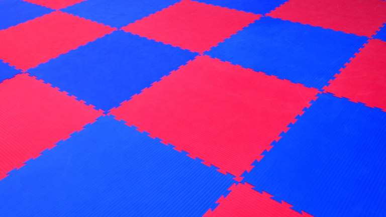 Rubber flooring tiles in a modern gym setting, showcasing durability and style.