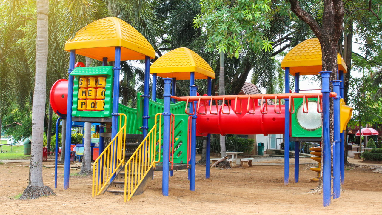 Children enjoying the Multiplay System on school playground equipment, featuring various play structures and activities.