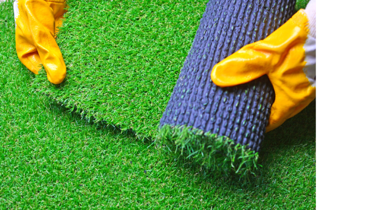 Close-up of artificial grass with visible drainage holes, designed to allow water to pass through effectively.