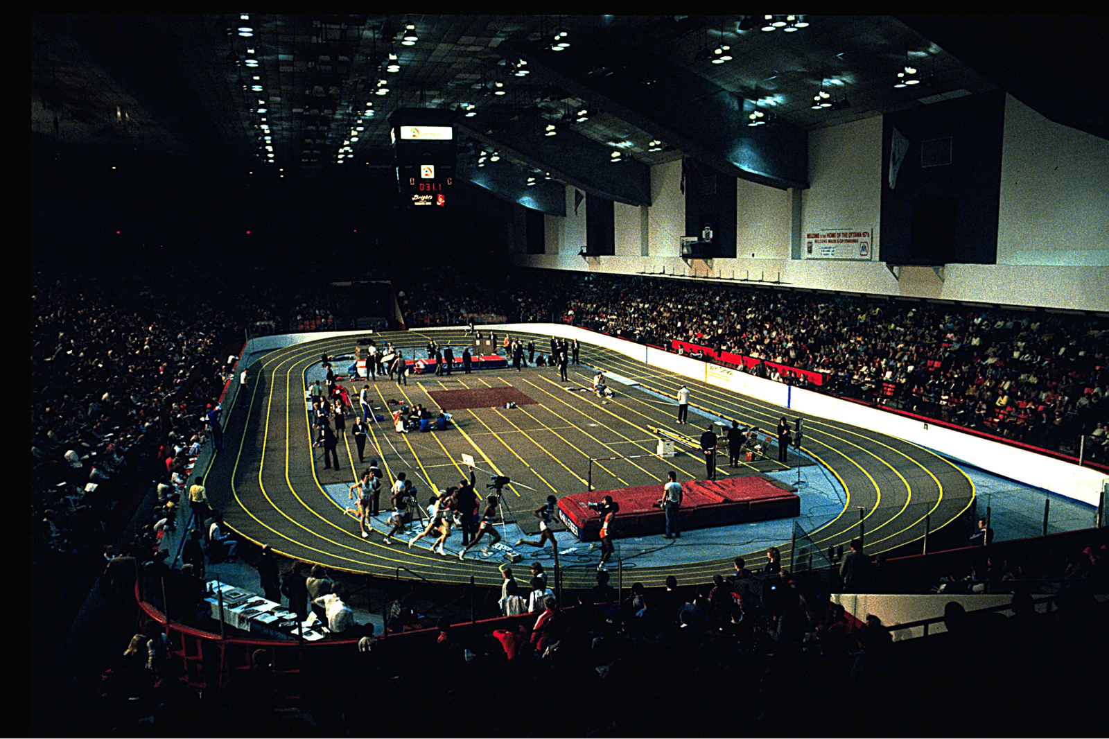 A group of athletes playing an indoor sport, working together to achieve a winning goal.