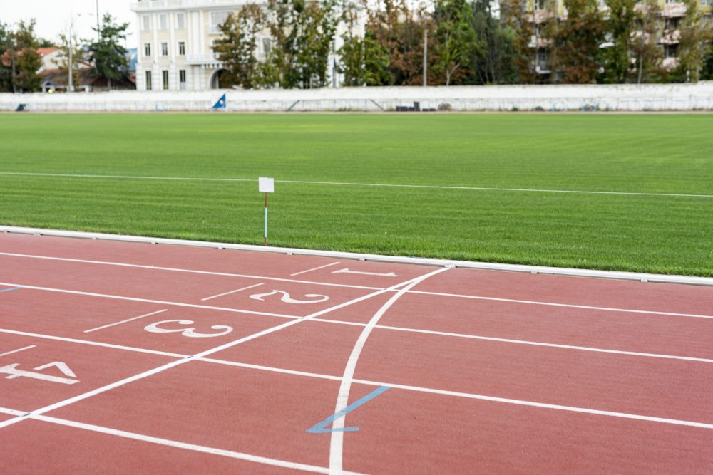 running-track-with-grass-field-sunny-day running-track-with-grass-field-sunny-day